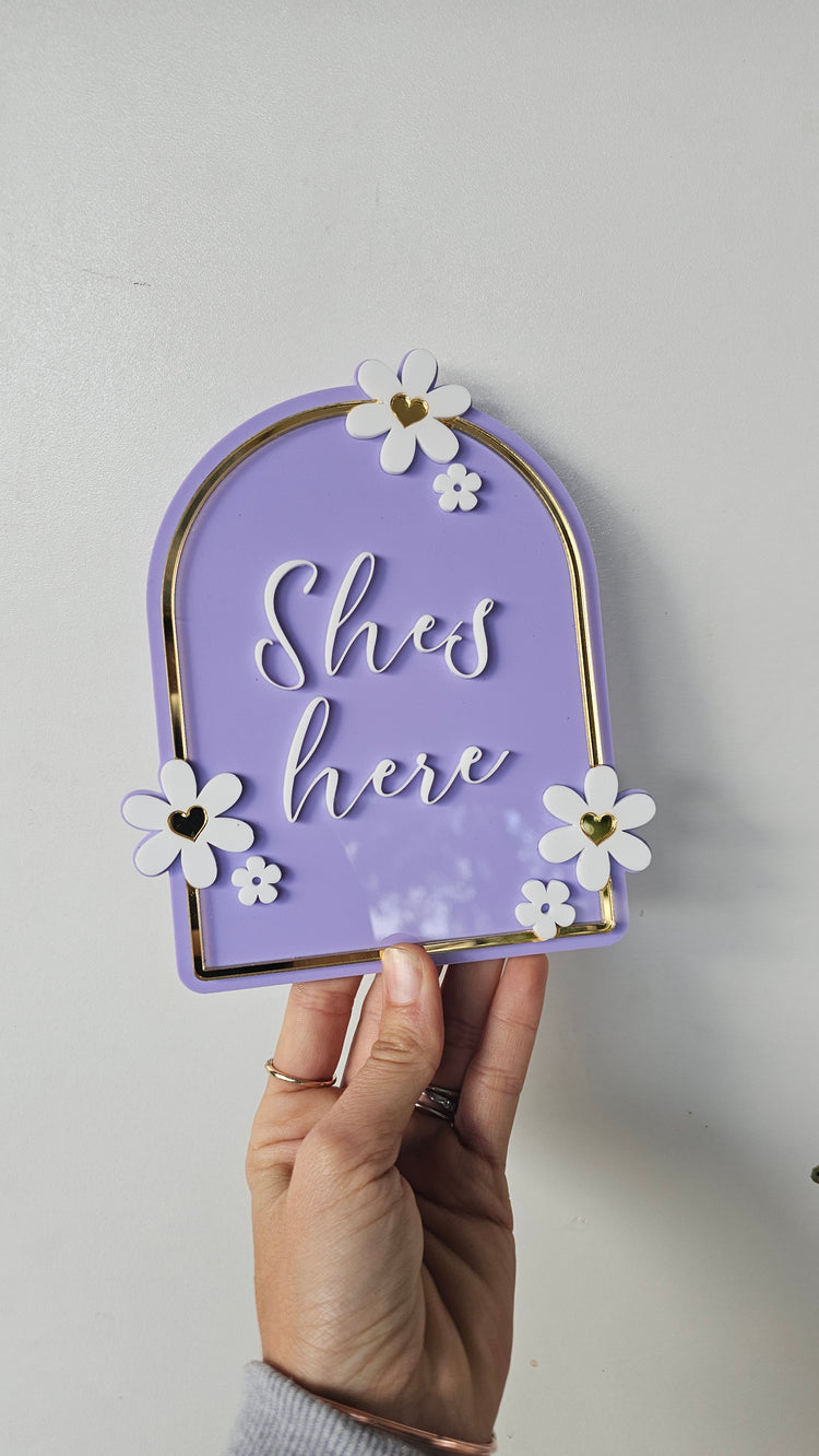 Shes here plaque